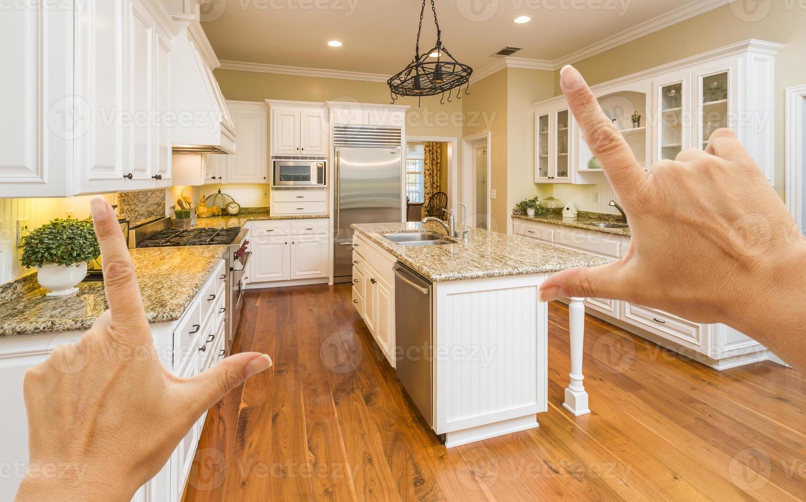 Hands Framing A Beautiful Custom Kitchen photo