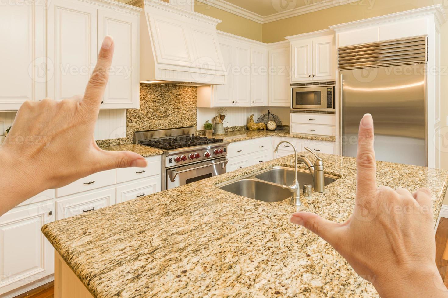 Hands Framing A Beautiful Custom Kitchen photo