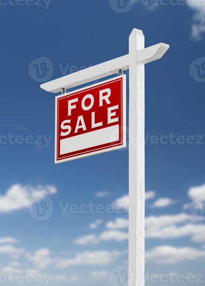 Left Facing For Sale Real Estate Sign on a Blue Sky with Clouds. photo