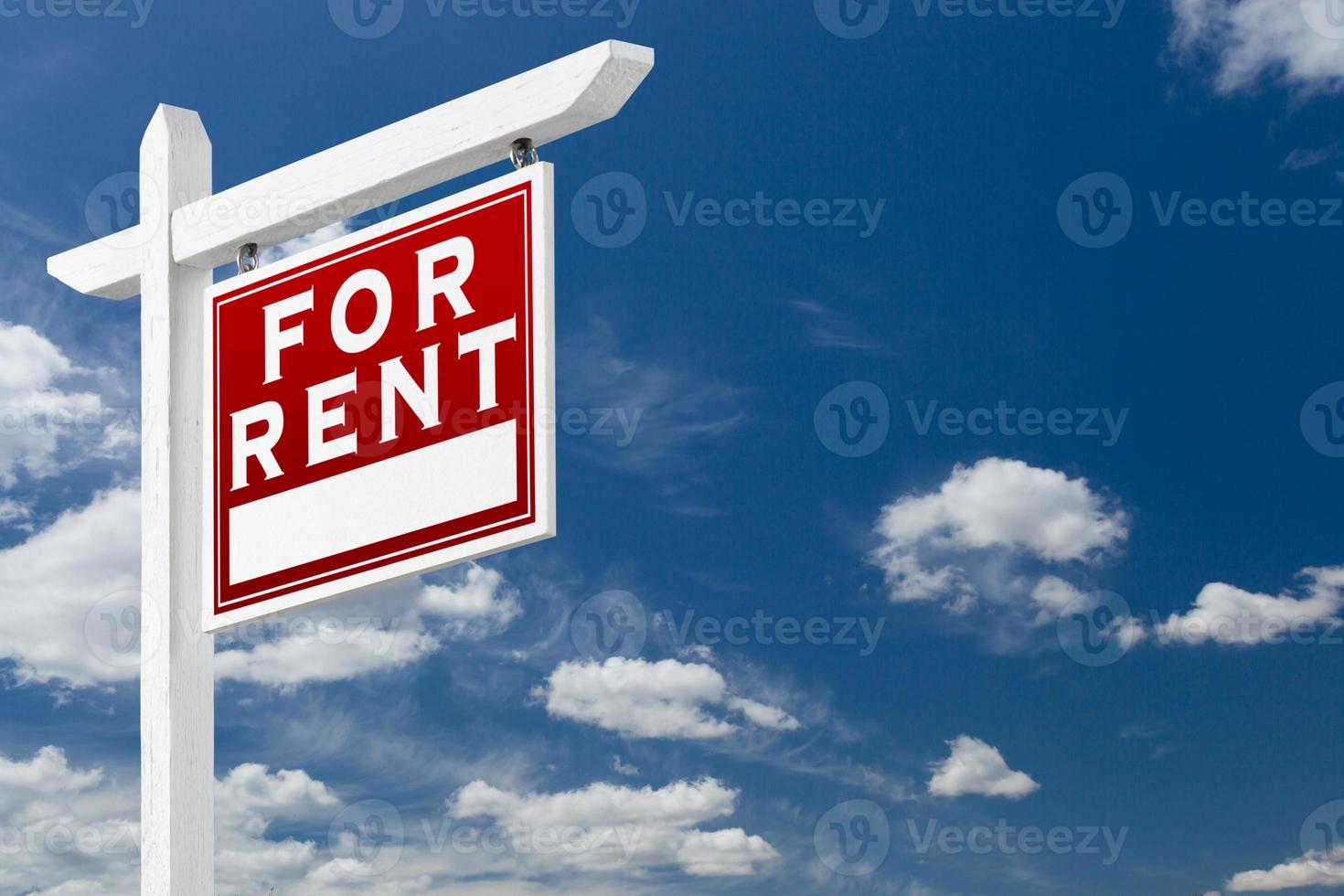 Right Facing For Rent Real Estate Sign Over Blue Sky and Clouds With Room For Your Text. photo