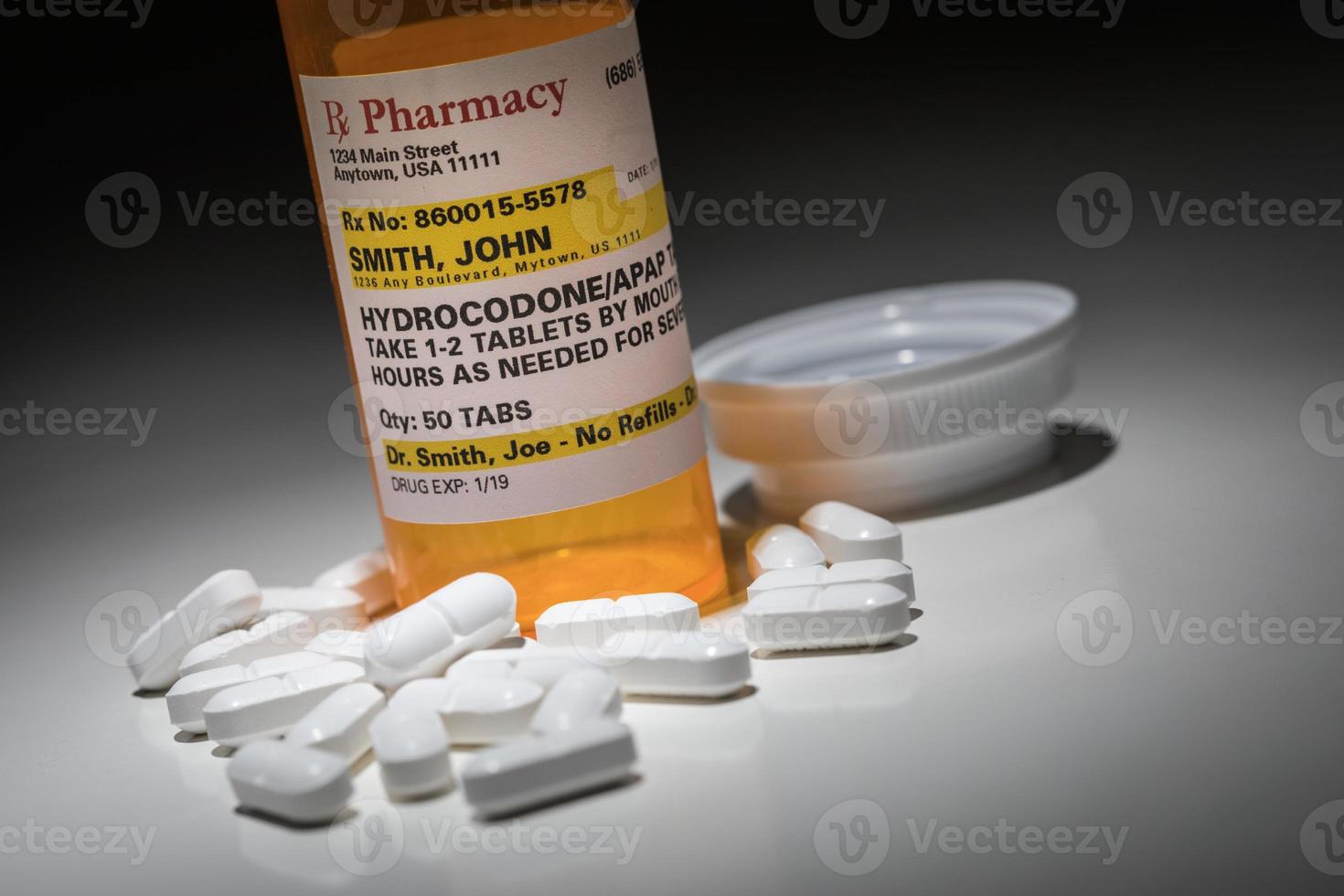 Hydrocodone Pills and Prescription Bottle with Non Proprietary Label. No model release required - contains fictitious information. photo