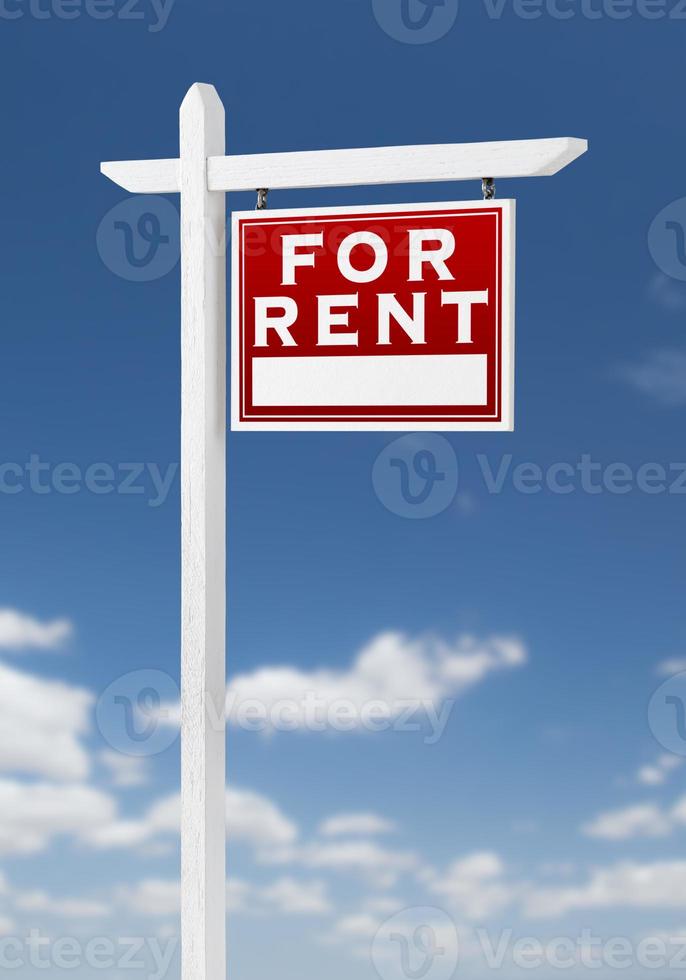 Right Facing For Rent Real Estate Sign on a Blue Sky with Clouds. photo