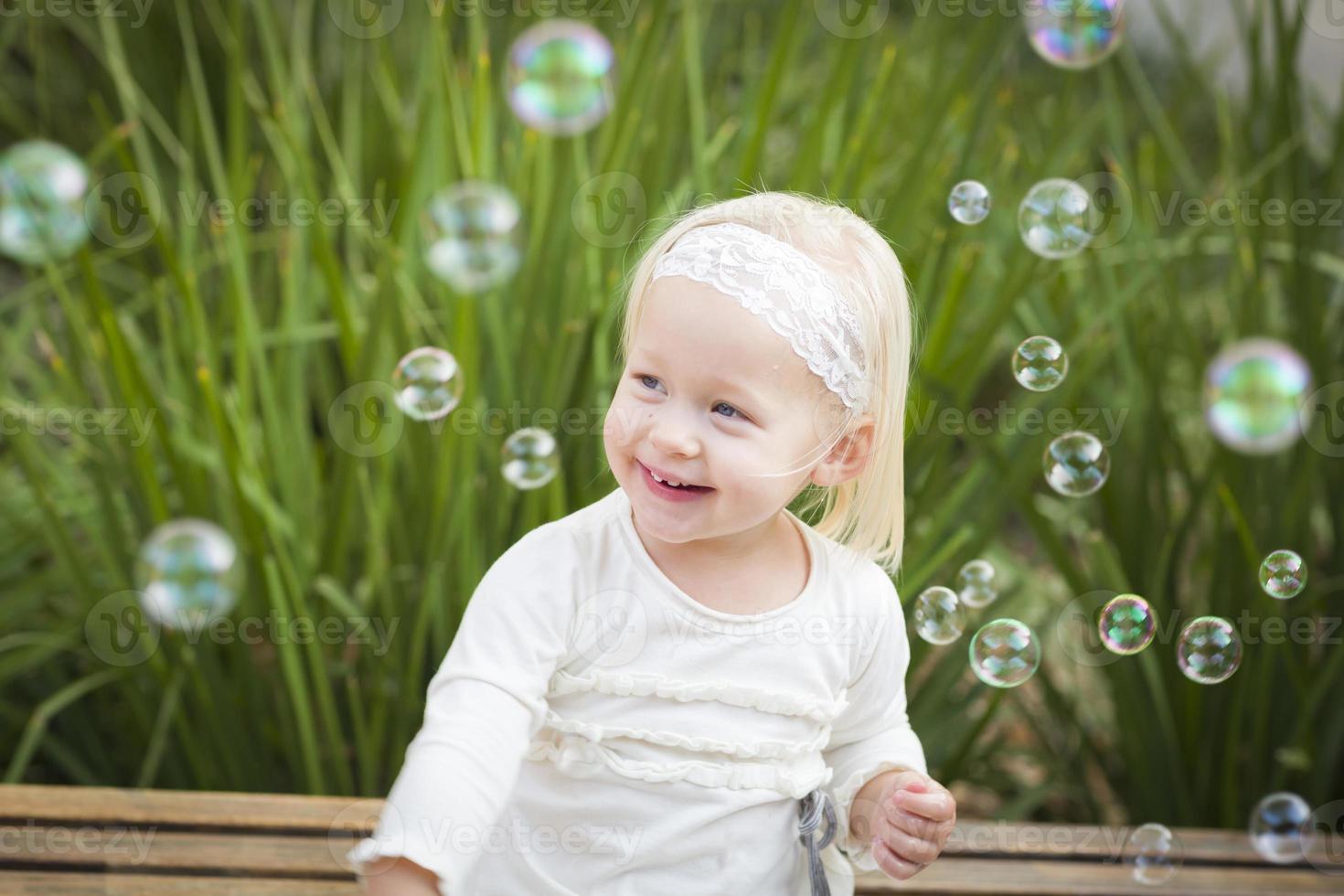 Adorable Little Girl Having Fun With Bubbles photo
