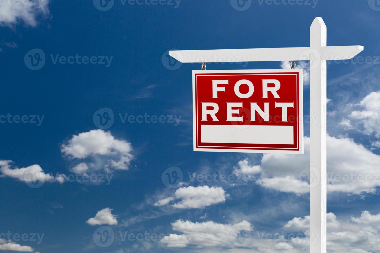 Left Facing For Rent Real Estate Sign Over Blue Sky and Clouds With Room For Your Text. photo