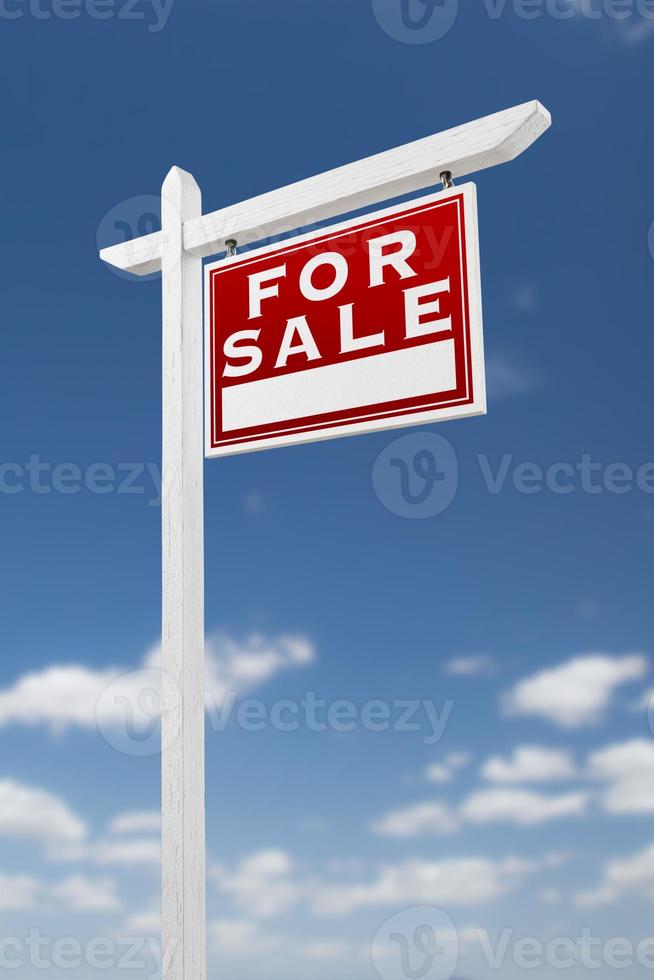 Right Facing For Sale Real Estate Sign on a Blue Sky with Clouds. photo