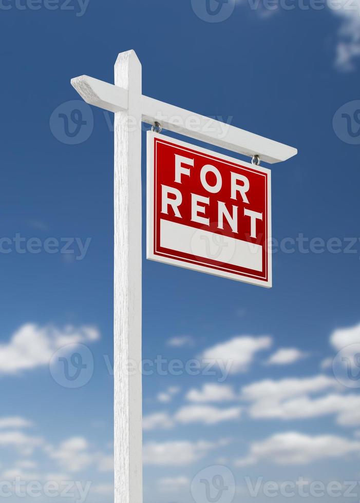 Right Facing For Rent Real Estate Sign on a Blue Sky with Clouds. photo