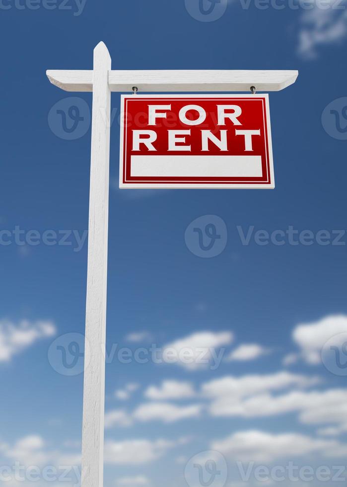 Right Facing For Rent Real Estate Sign on a Blue Sky with Clouds. photo