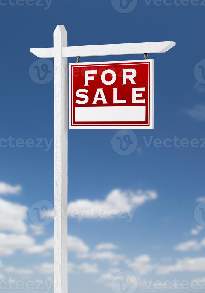Right Facing For Sale Real Estate Sign on a Blue Sky with Clouds. photo