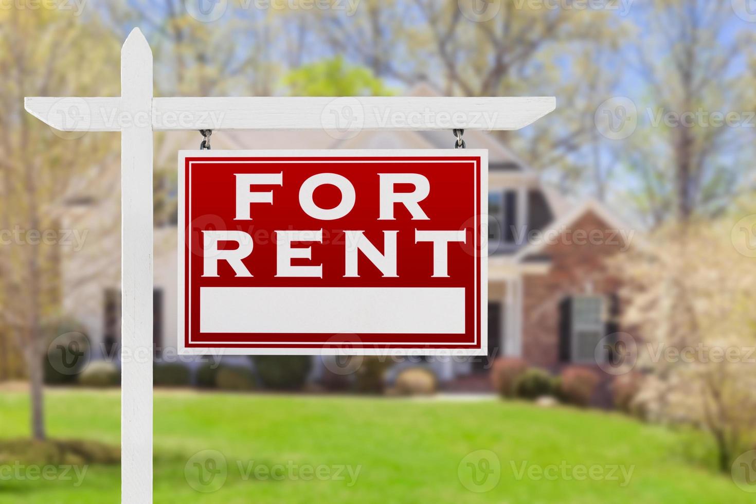 Right Facing For Rent Real Estate Sign In Front of House. photo