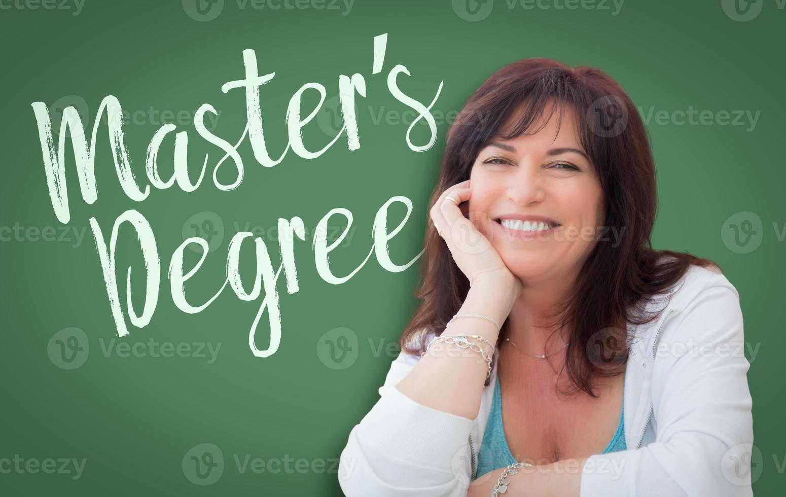 Master's Degree Written On Green Chalkboard Behind Smiling Middle Aged Woman photo