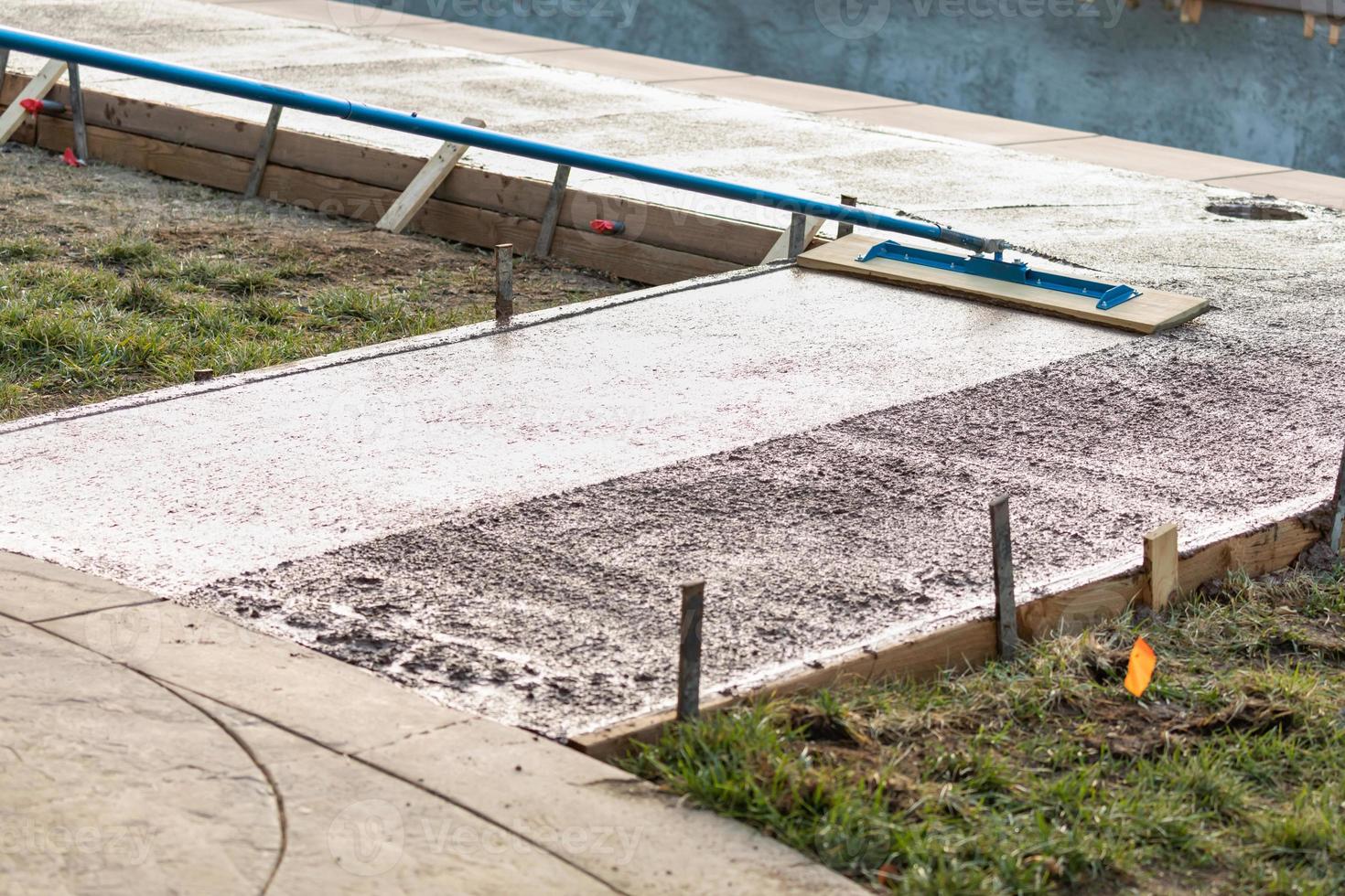 Construction Worker Smoothing Wet Cement With Trowel Tool photo