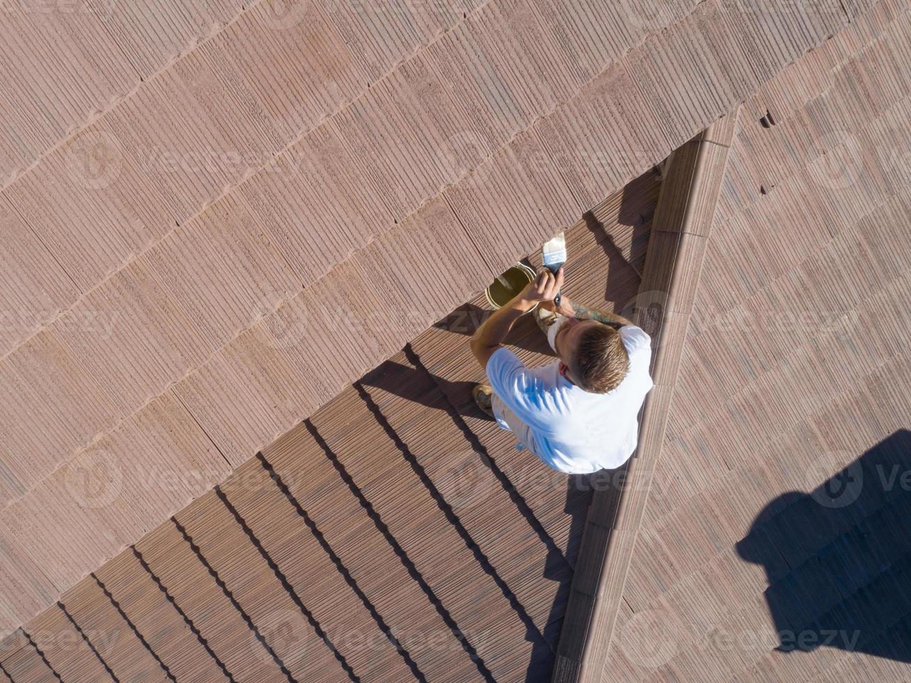 Professional Painter Using A Brush to Paint House Fascia photo