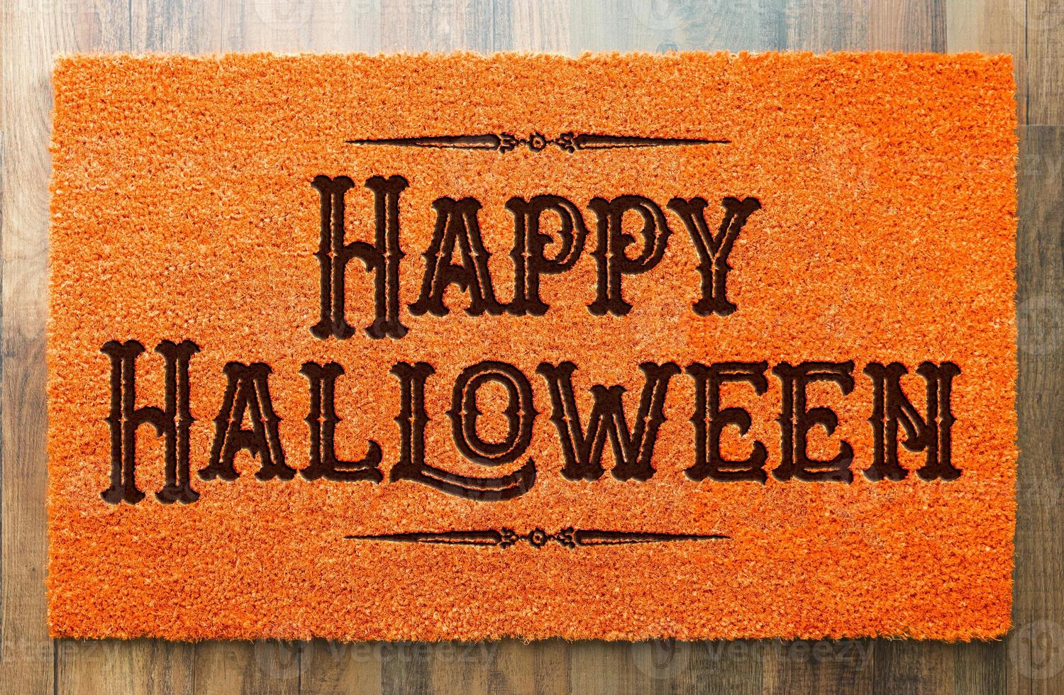 Happy Halloween Orange Welcome Mat On Wood Floor Background photo