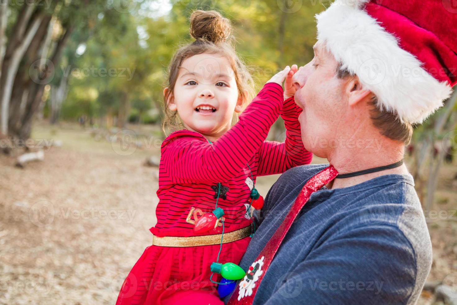 Festive Grandfather and Mixed Race Baby Girl Outdoors photo