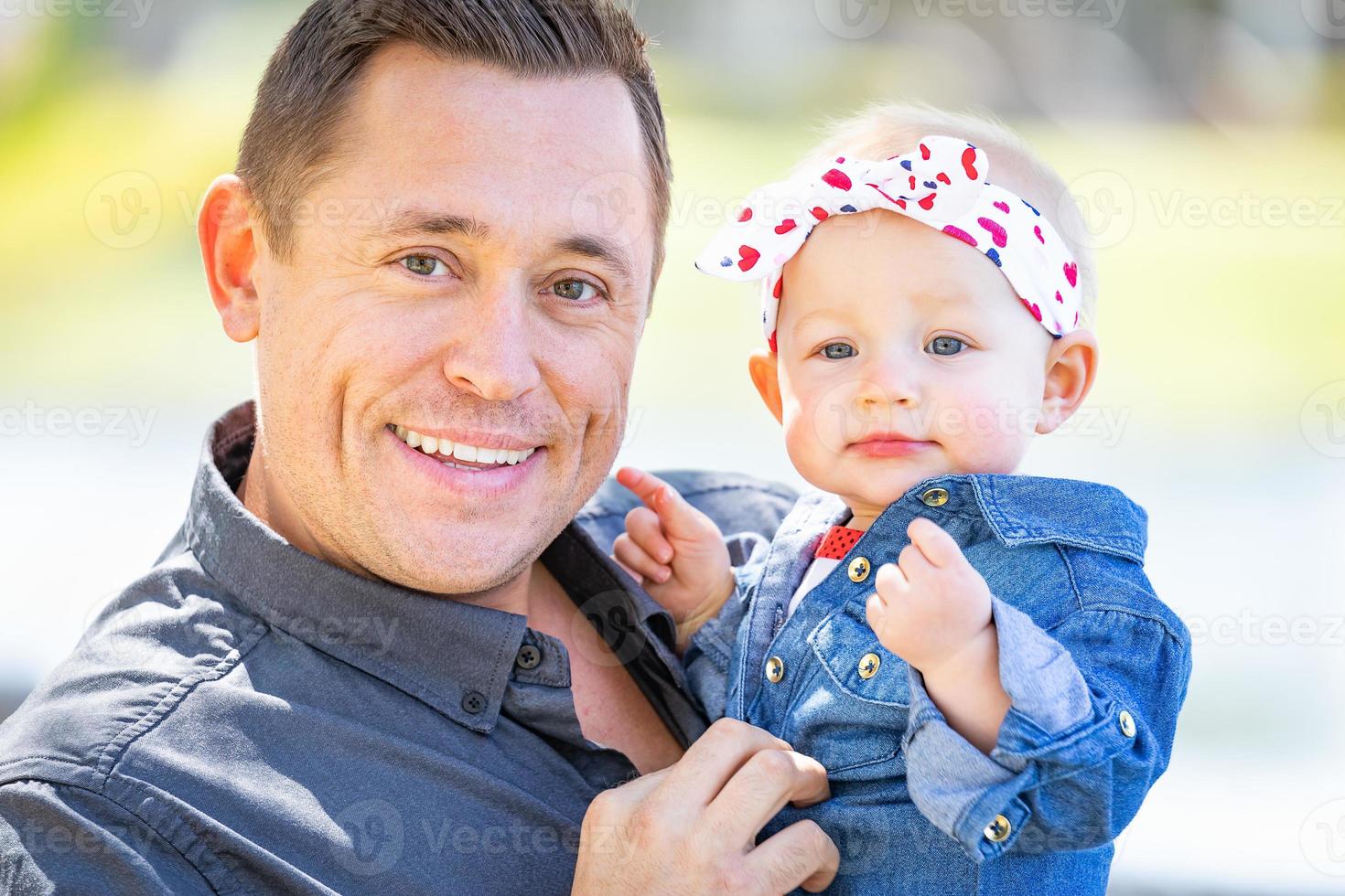 Young Caucasian Father and Baby Girl At The Park photo