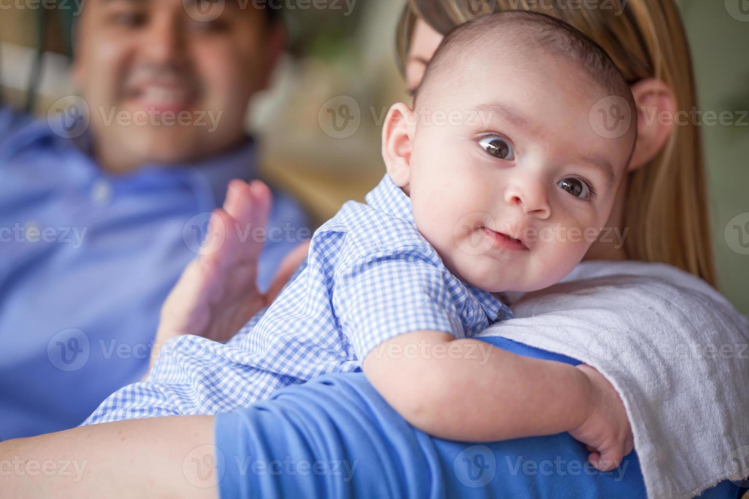 Happy Attractive Mixed Race Couple Burping Their Son photo