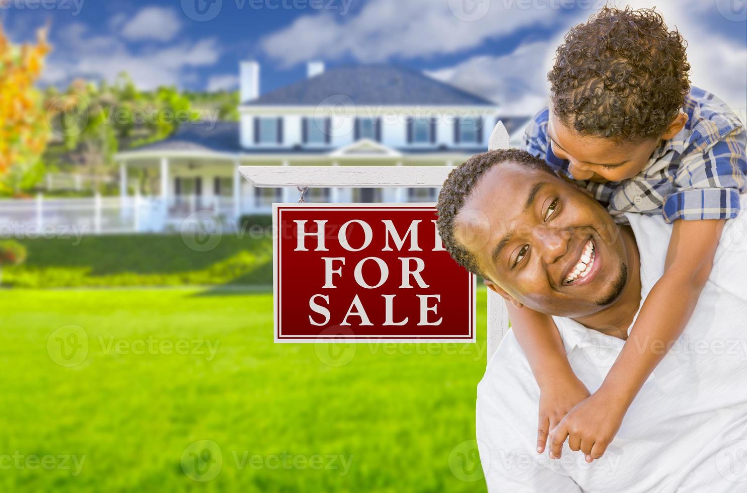 Father and Son In Front of Sale Sign and House photo