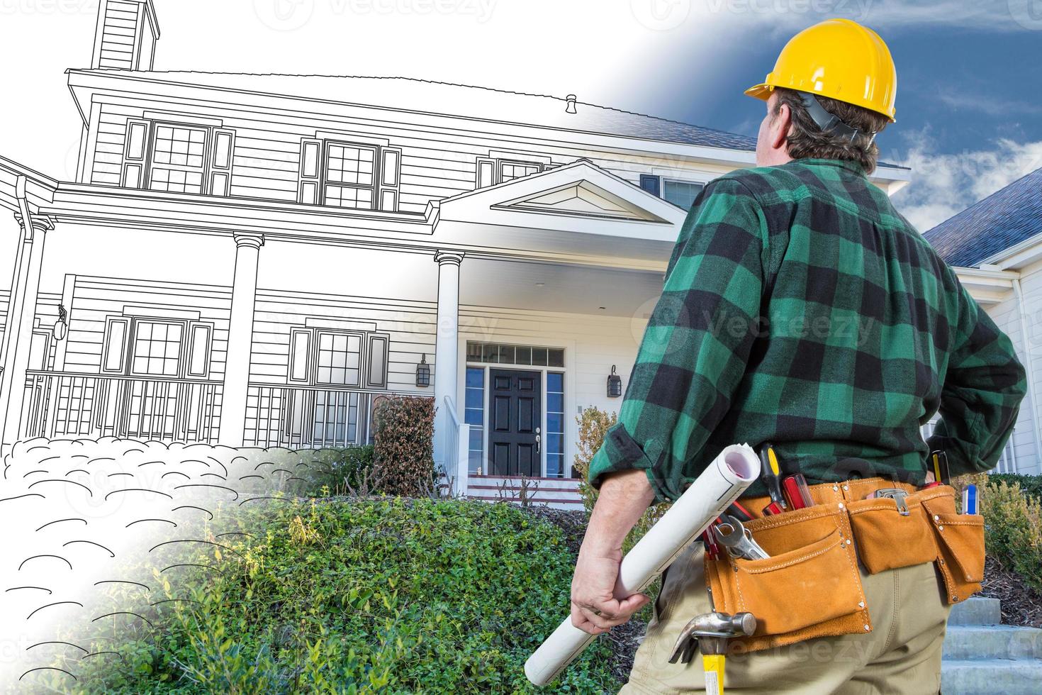 Male Contractor with Hard Hat and Tool Belt Looking At Custom House Drawing Photo Combination On White.