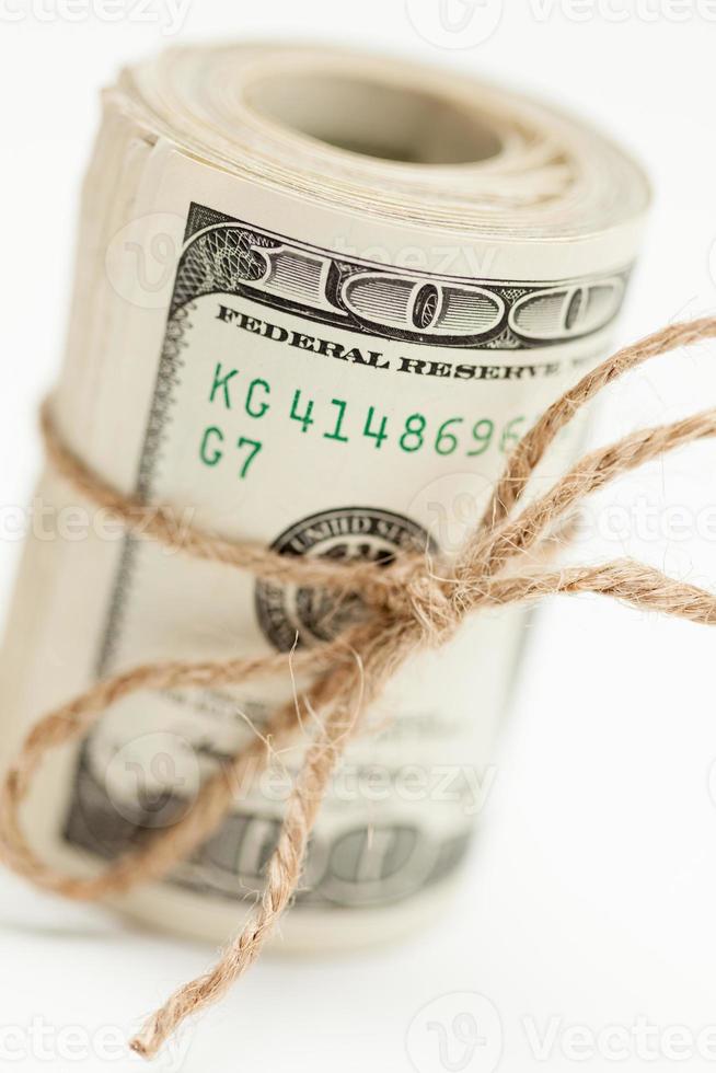 Roll of One Hundred Dollar Bills Tied in Burlap String on White photo