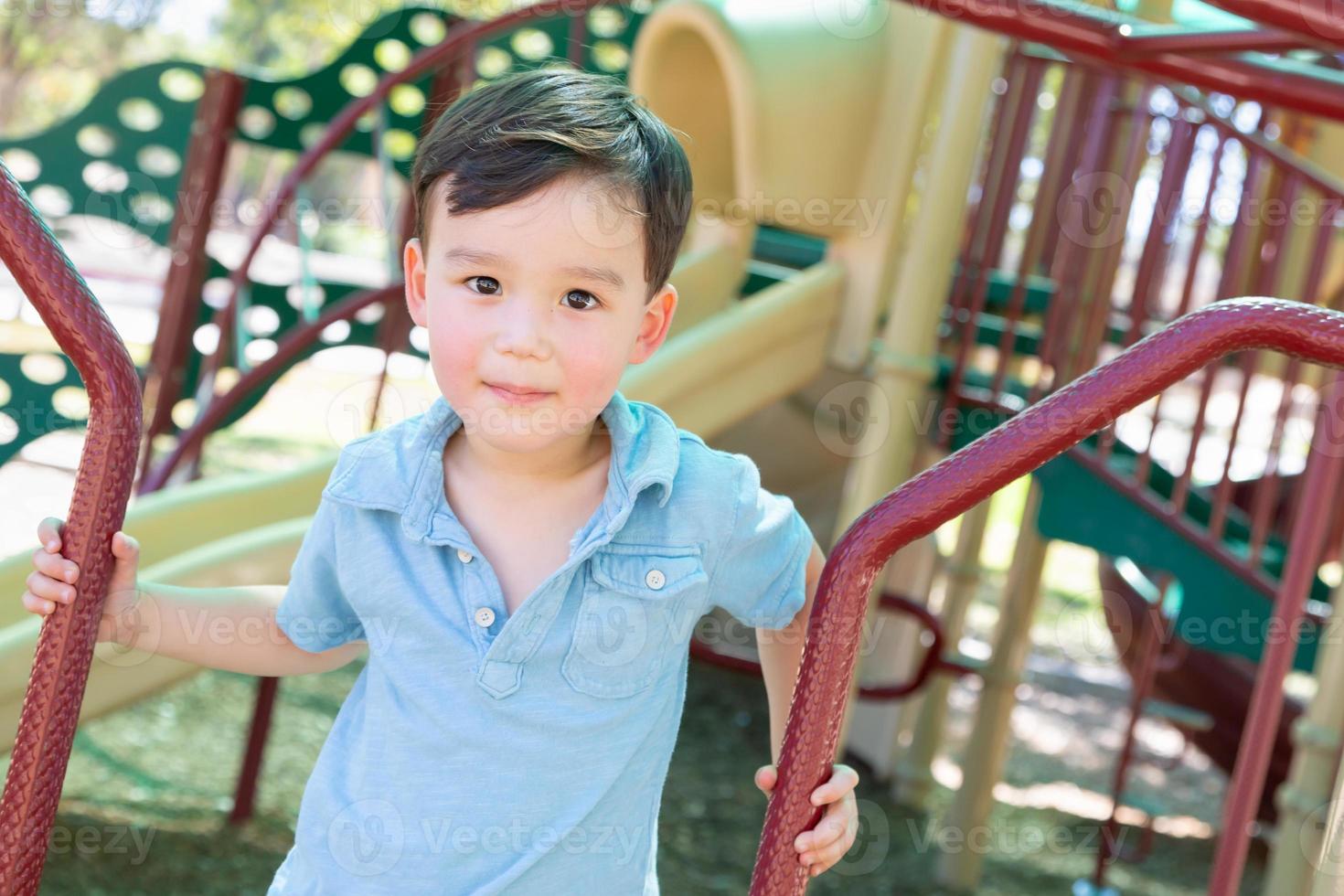 Chinese and Caucasian Boy Having Fun At The Playground. photo