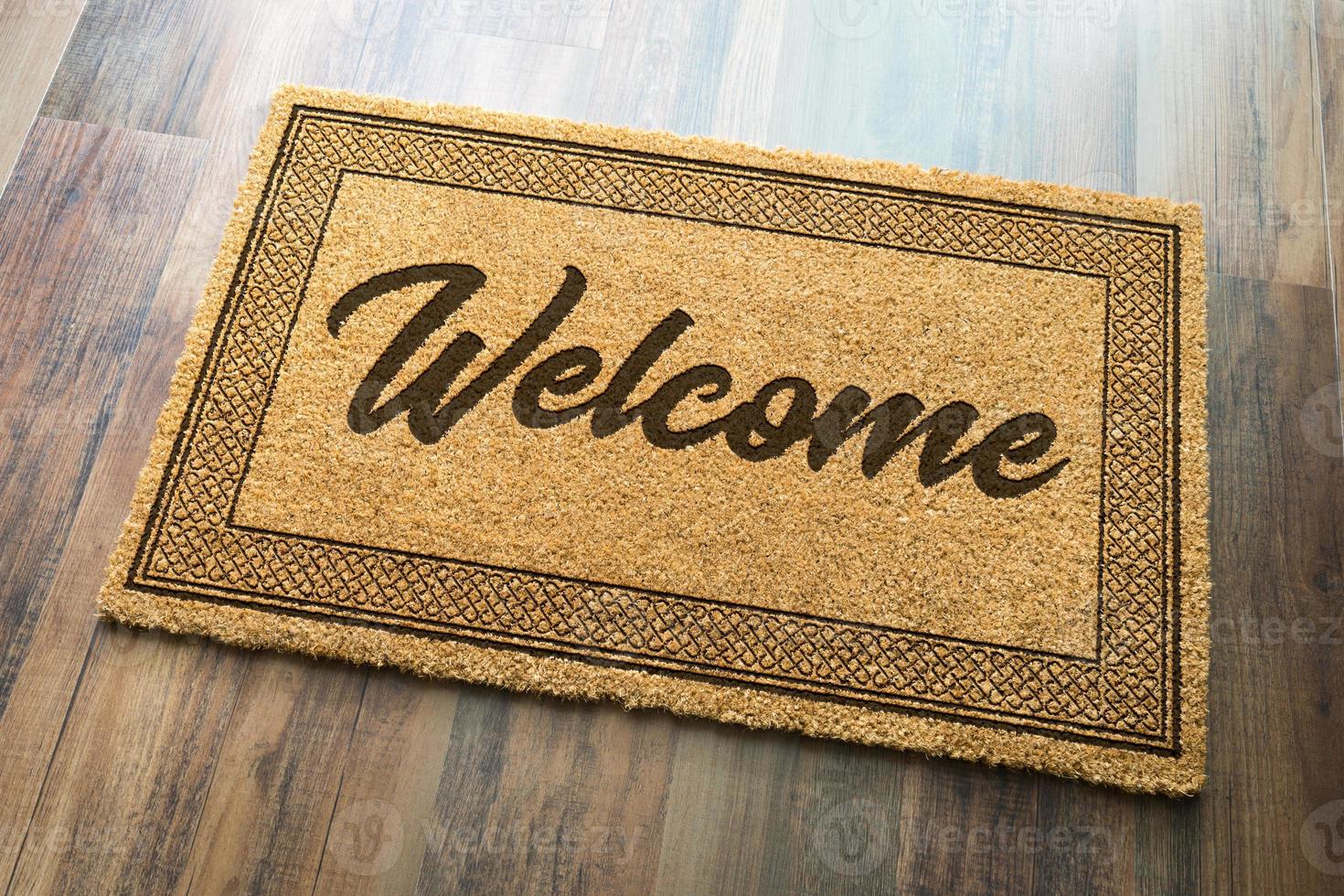 Welcome Mat On A Wood Floor Background photo