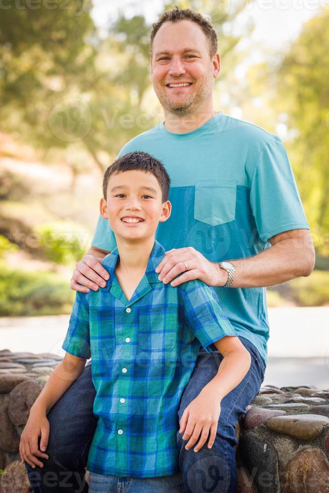 Outdoor portrait of biracial Chinese and Caucasian father and son. photo