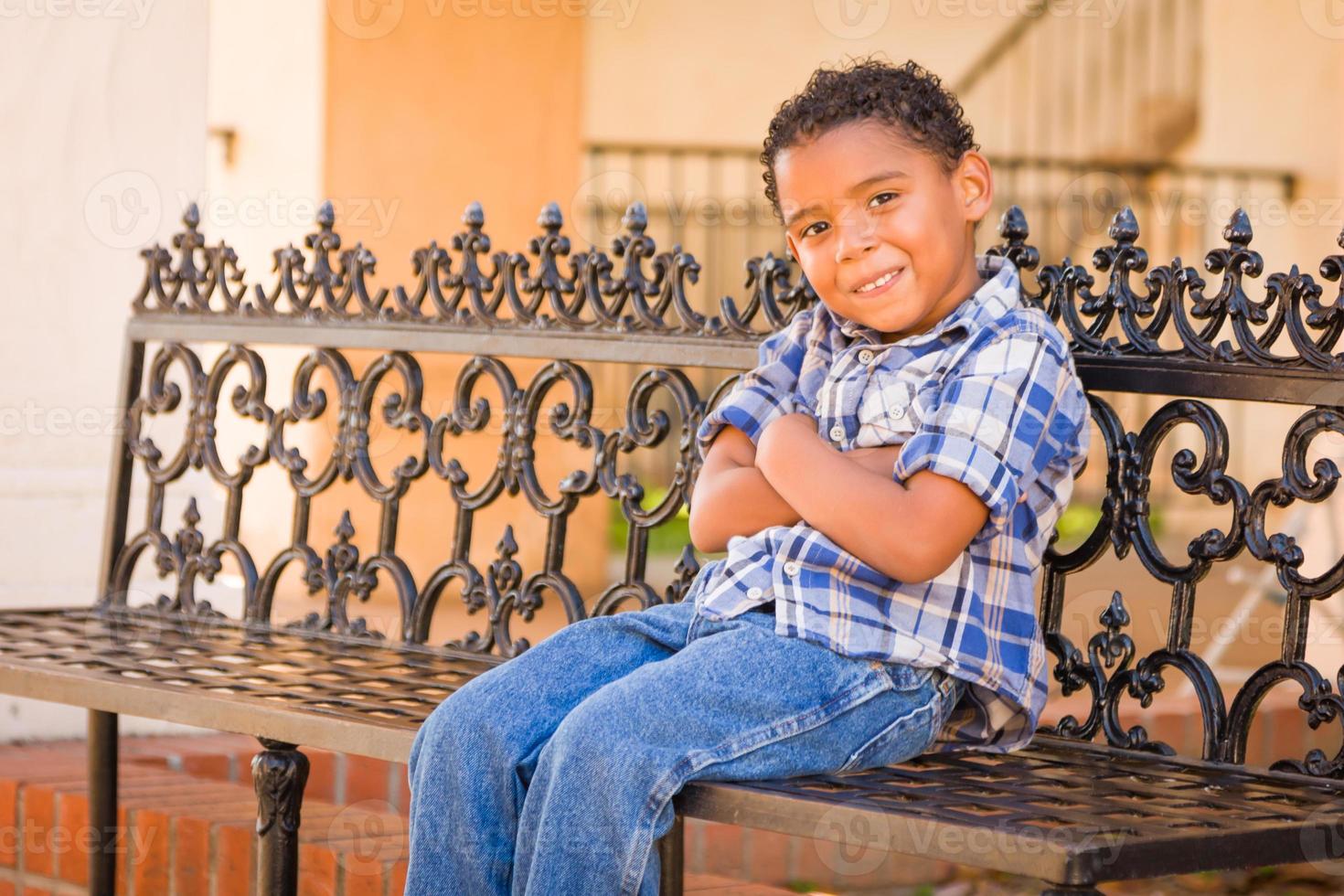 Handsome African American and Mexican Boy Sitting on Park Bench photo