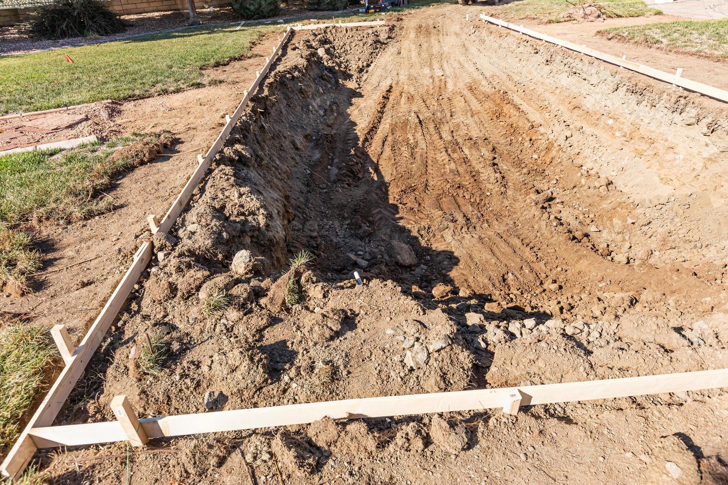 Freshly Dug Hole In Yard Preparing For Swimming Pool Installation photo