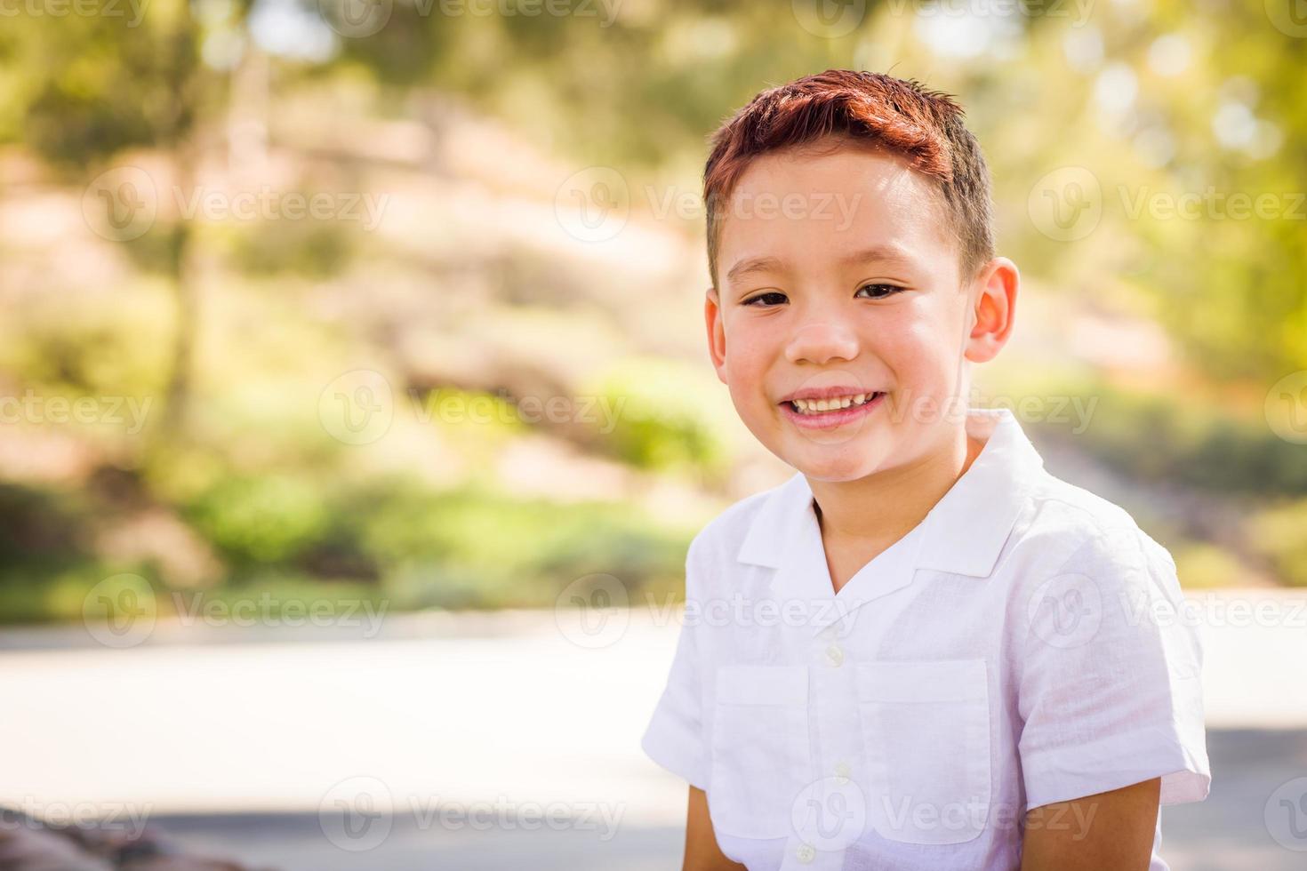 Outdoor portrait of a biracial Chinese and Caucasian boy. photo