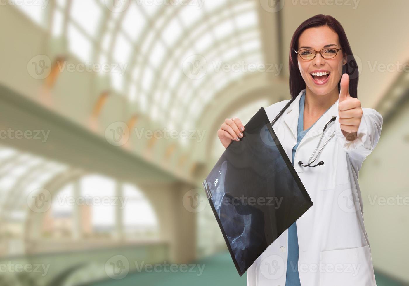 Happy Female Doctor or Nurse Holding X-ray Inside Hospital photo