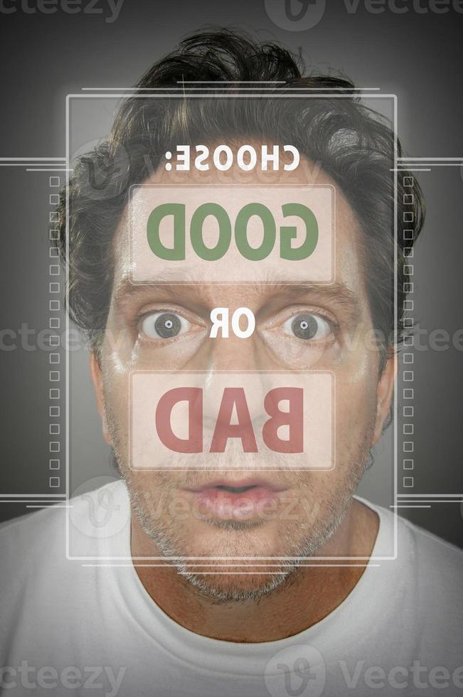 Dumbfounded Looking Man In Front of Touch Screen Choosing Good or Bad photo