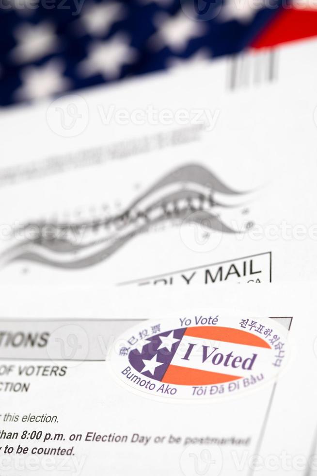 Vote-By-Mail Ballot Envelope and Voting Instructions Laying On American Flag photo