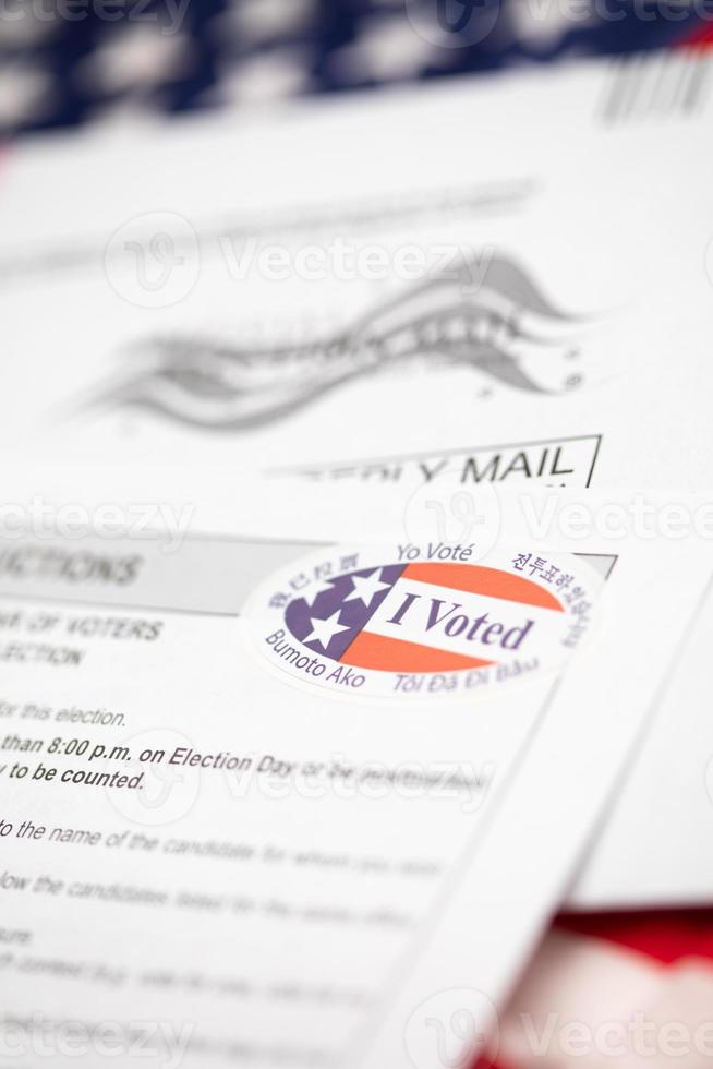 Vote-By-Mail Ballot Envelope and Voting Instructions Laying On American Flag photo