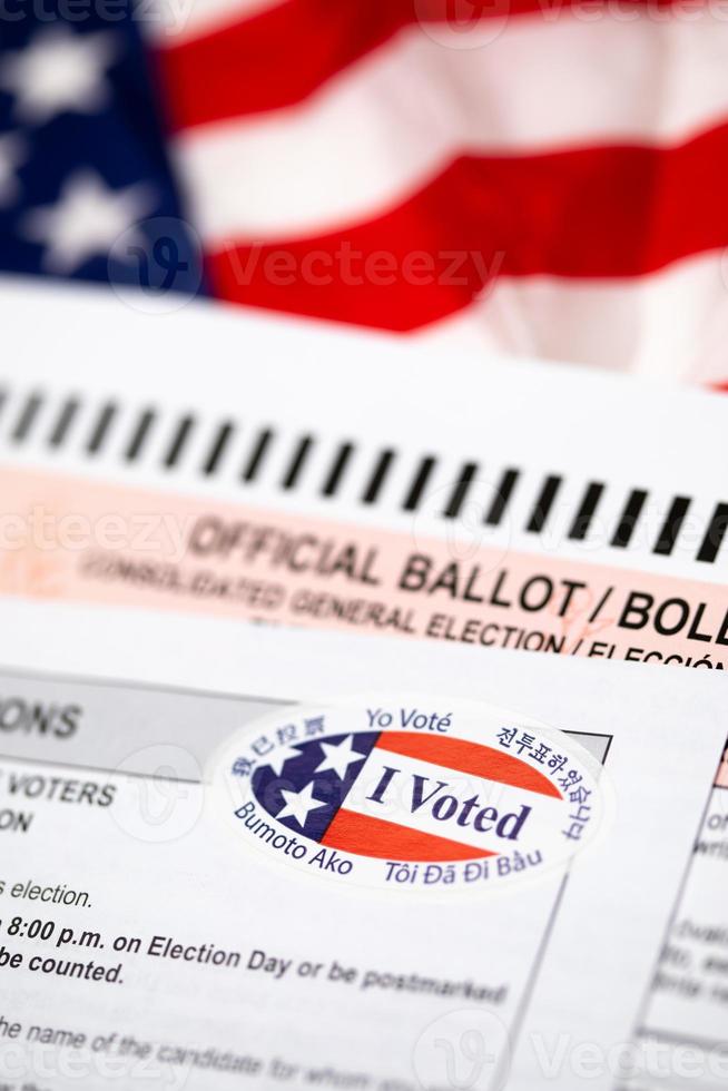 Official Ballot and Voting Instructions with I Voted Sticker Laying on American Flag photo