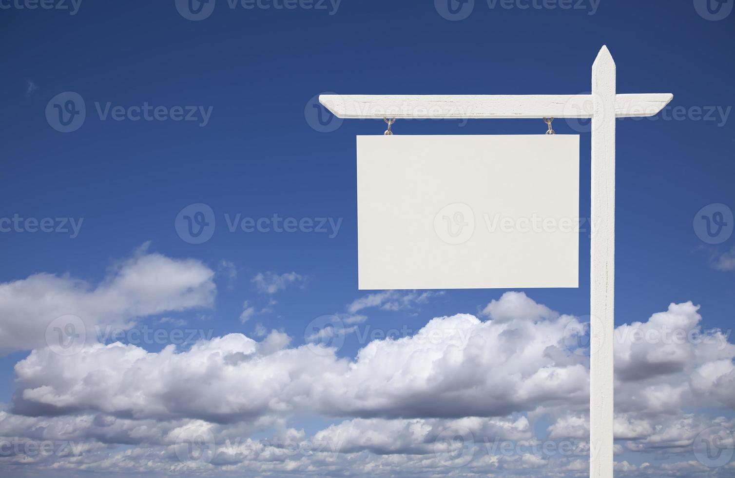 Blank White Real Estate Sign Over Sky and Clouds photo