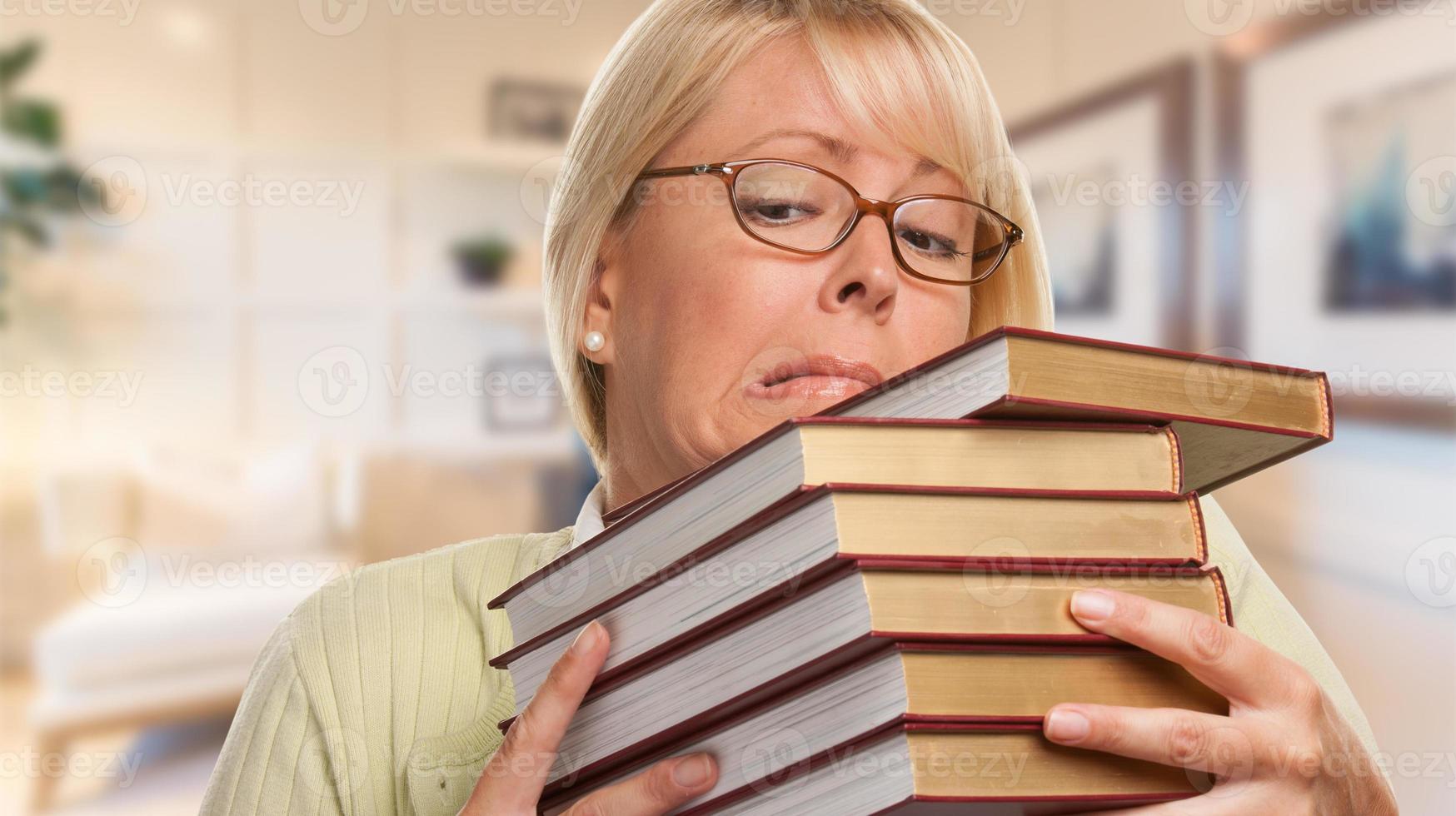 Beautiful Expressive Student or Businesswoman with Books in Office. photo