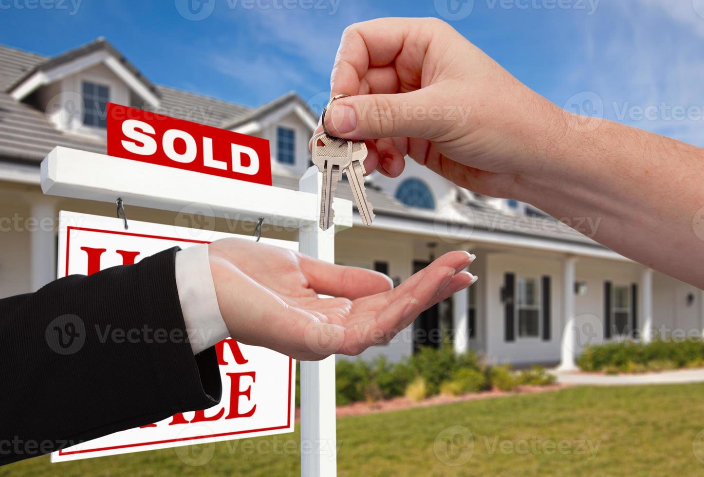 Handing Over the House Keys in Front of Sold New Home photo
