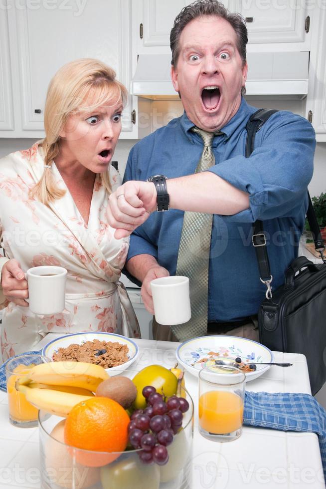 Stressed Couple in Kitchen Late for Work photo
