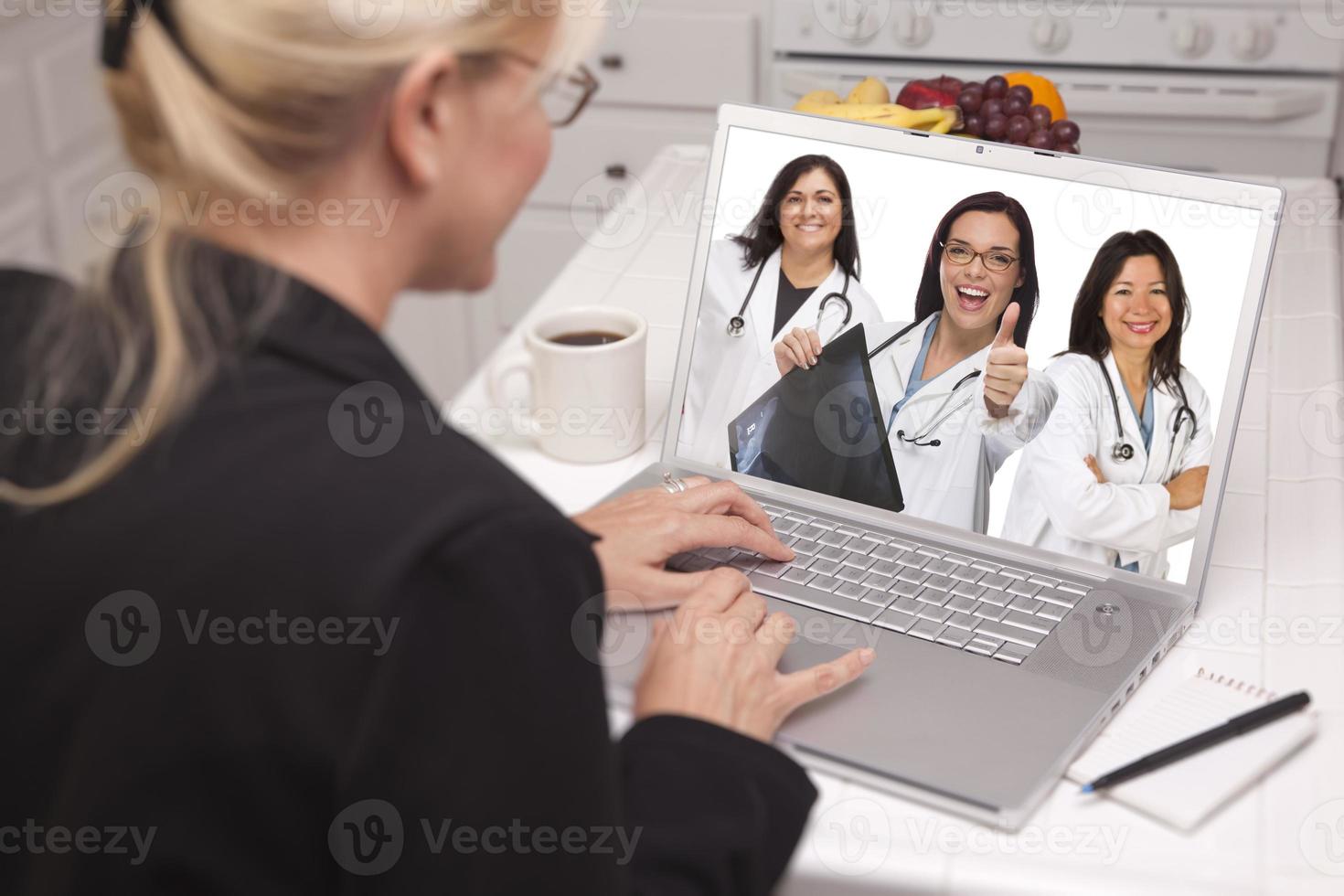 Woman Using Laptop Viewing Three Doctors with Thumbs Up photo
