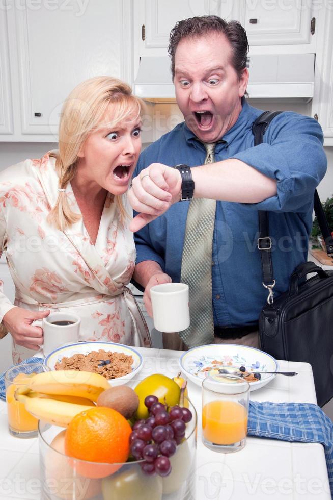 Stressed Couple in Kitchen Late for Work photo