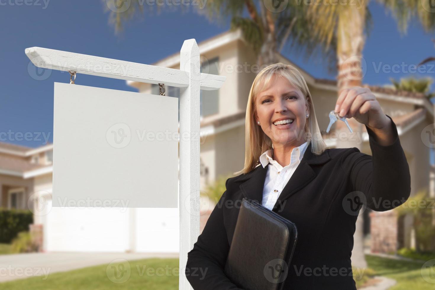 Blank Sign and Real Estate Agent Handing Over the Keys photo