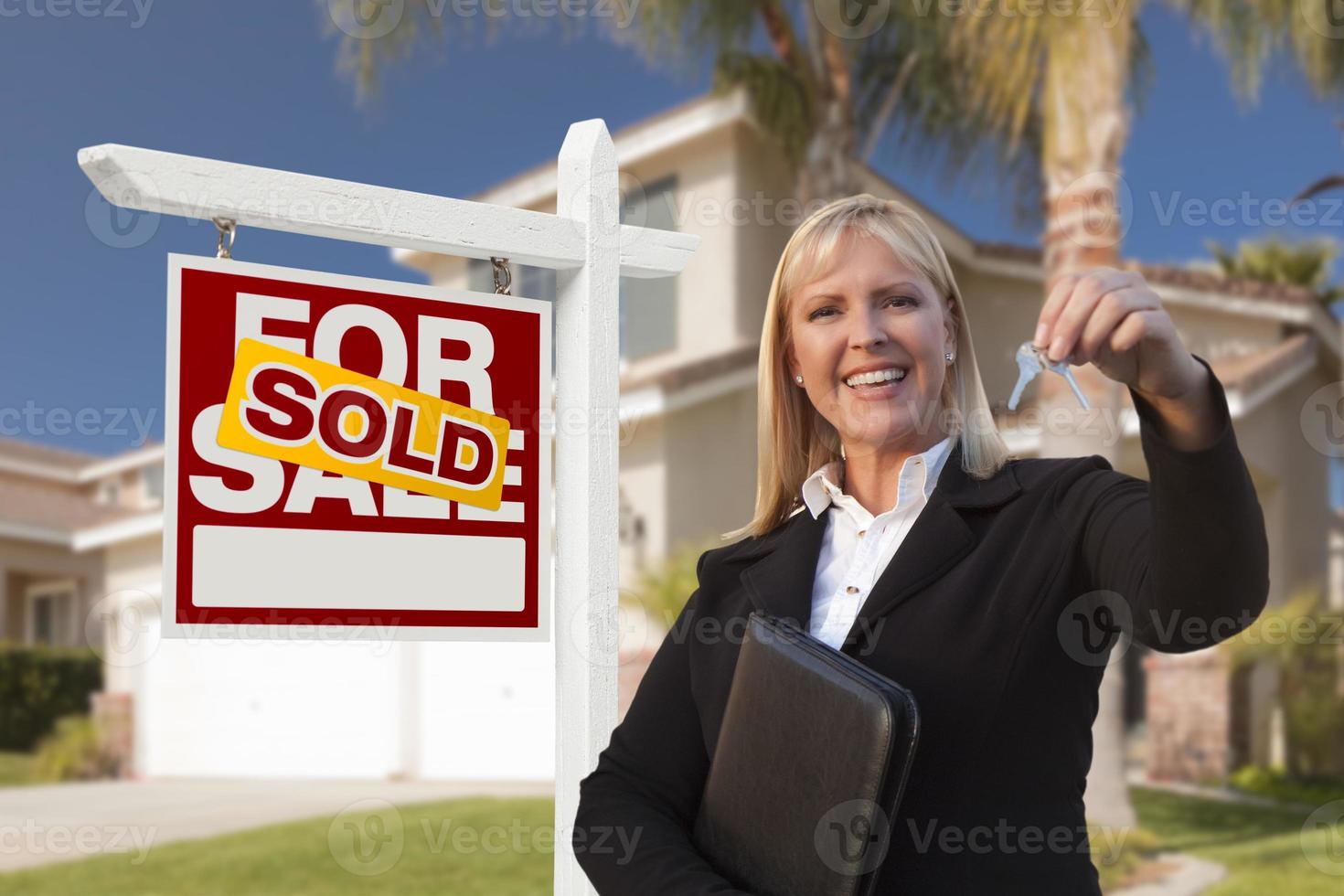 Female Real Estate Agent Handing Over the House Keys photo