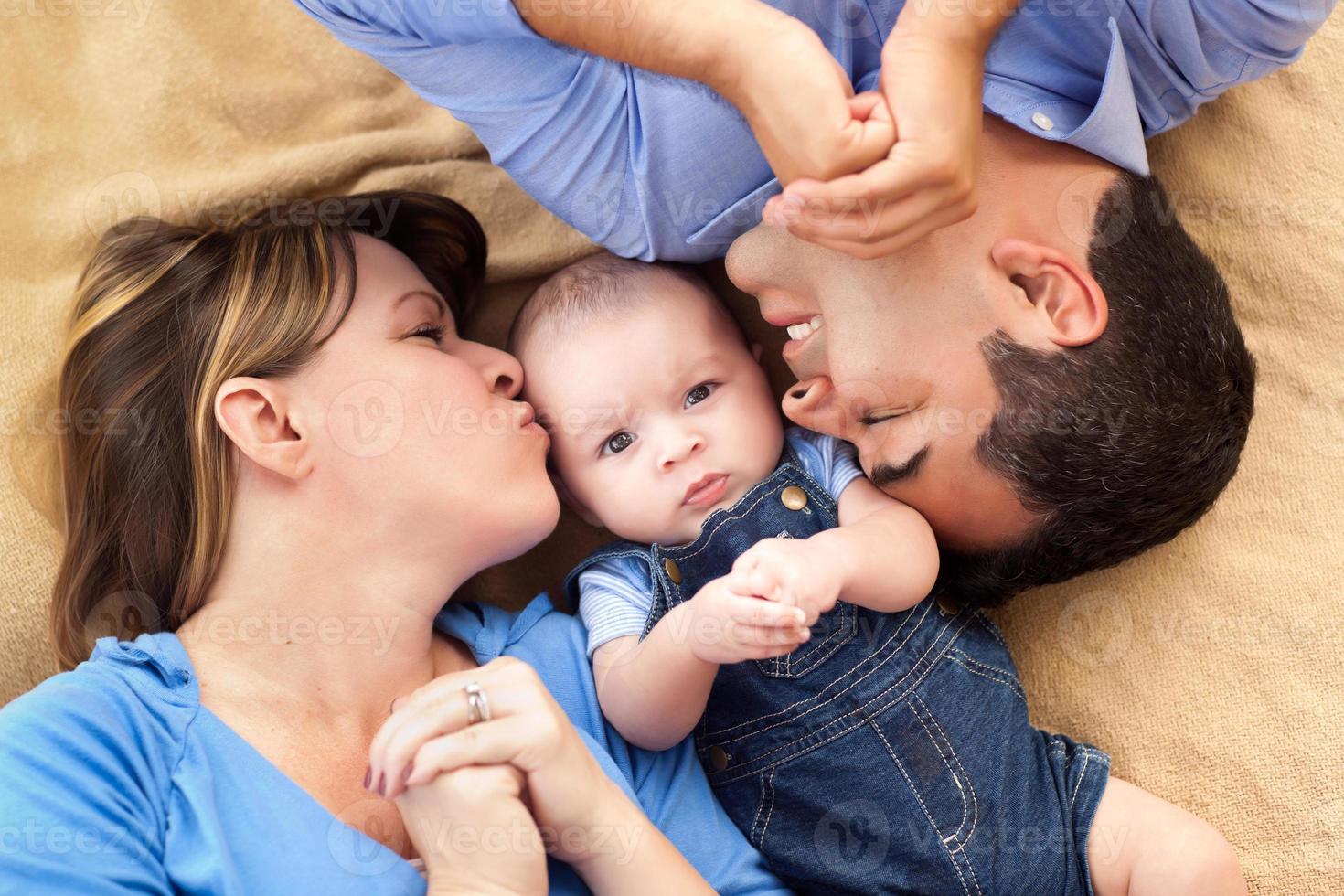 Mixed Race Family Playing on the Blanket photo
