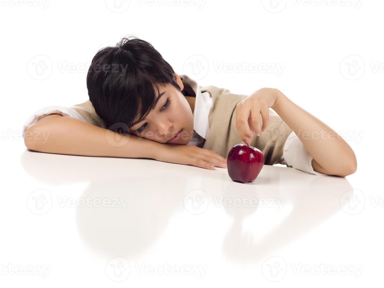 Melancholy Mixed Race Young Adult Female Sitting with Apple Isolated photo