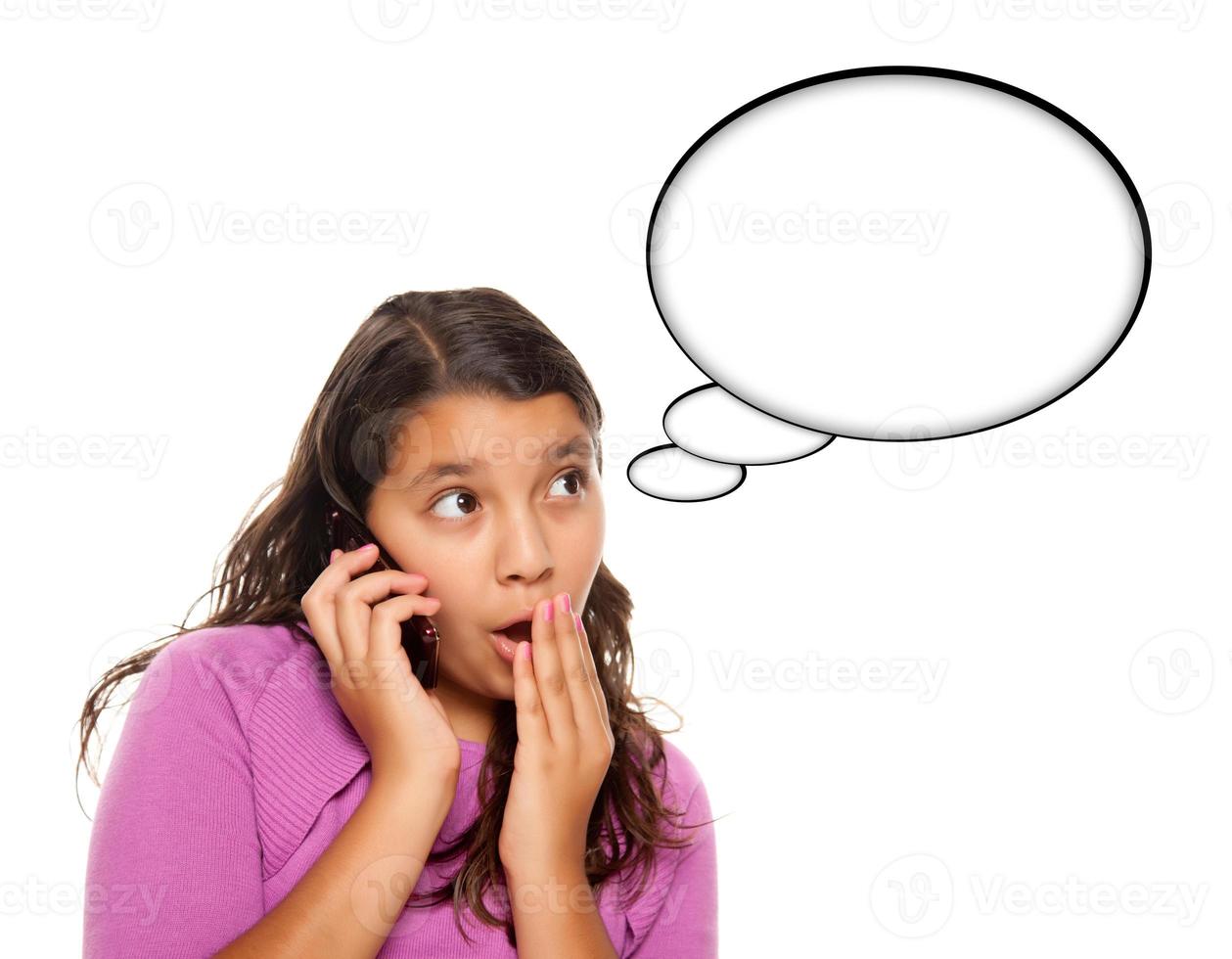 Shocked Hispanic Teen Aged Girl on Phone with Blank Thought Bubble photo