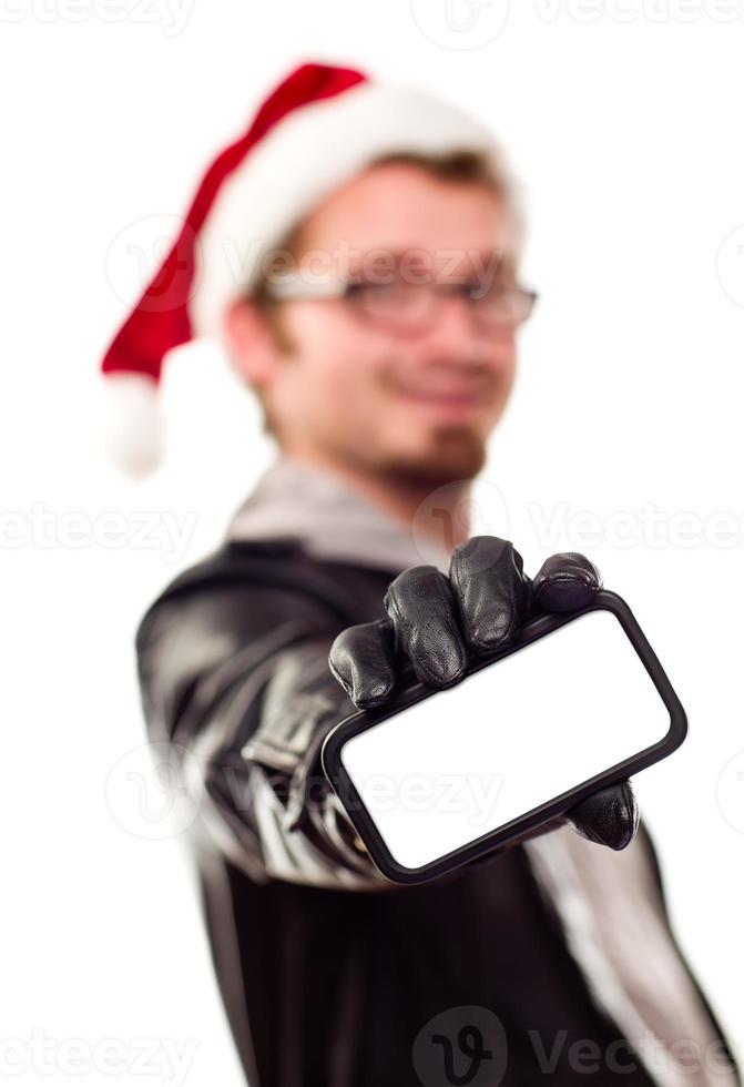 hombre con gorro de Papá Noel sosteniendo un teléfono celular en blanco foto