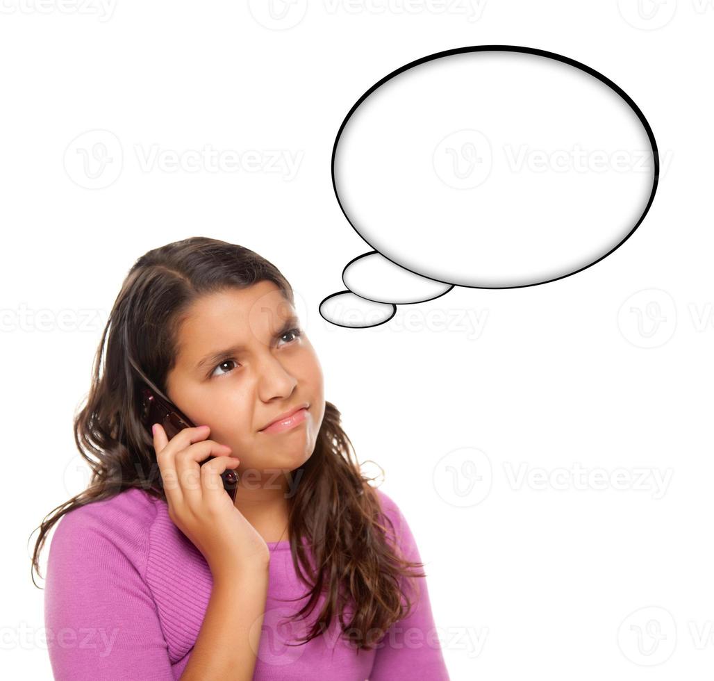 Frowning Hispanic Teen Aged Girl on Phone with Blank Thought Bubble photo