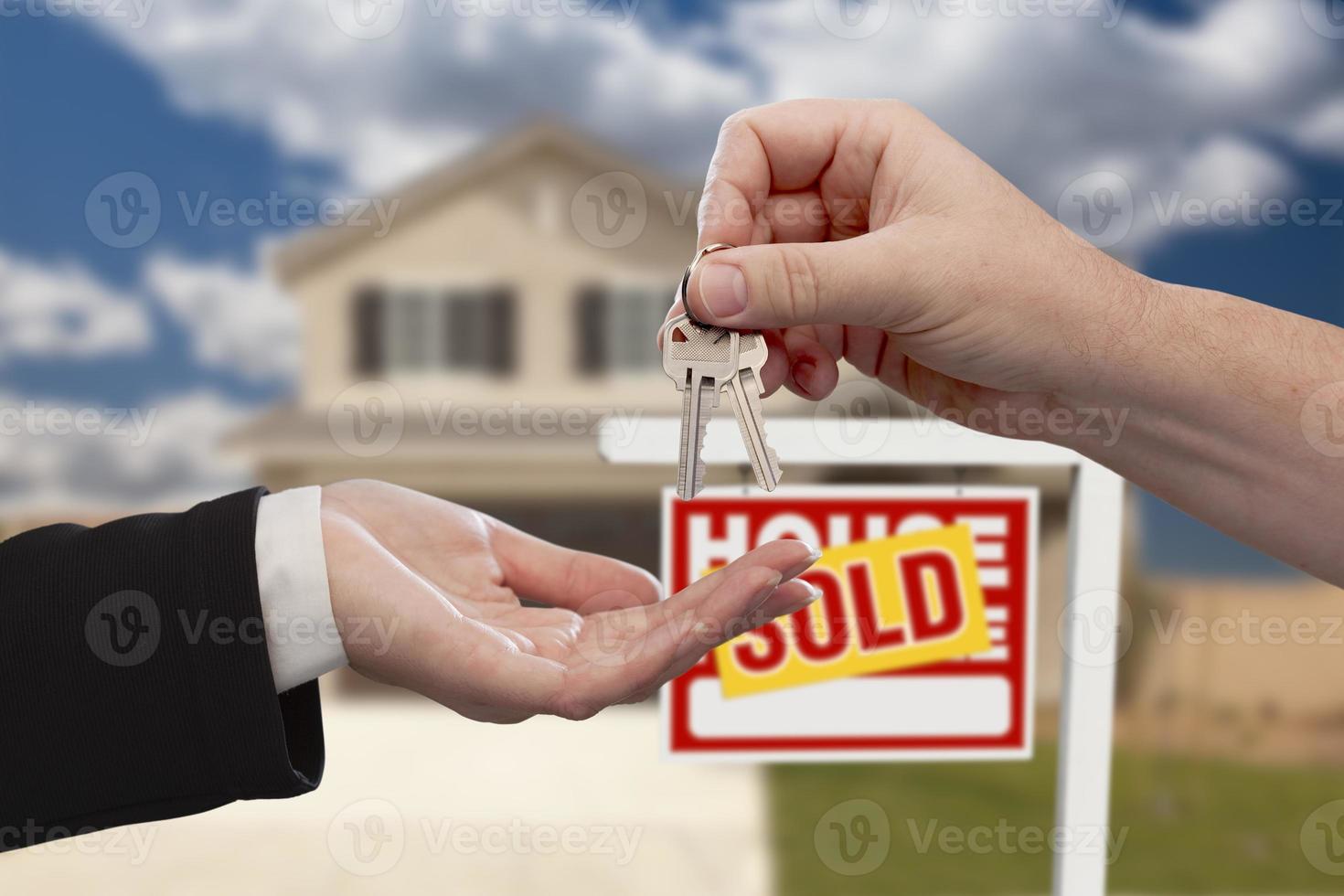 Handing Over the House Keys in Front of Sold New Home photo