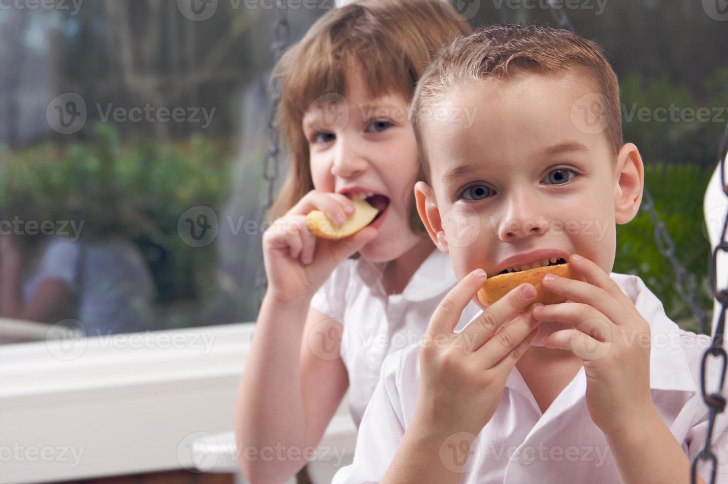 Sister and Brother Eating an Apple photo