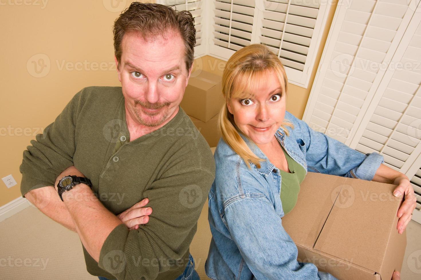 Goofy Couple and Moving Boxes in Empty Room photo